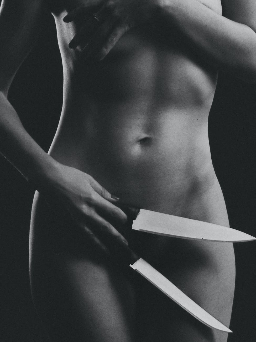 woman holding two kitchen knives