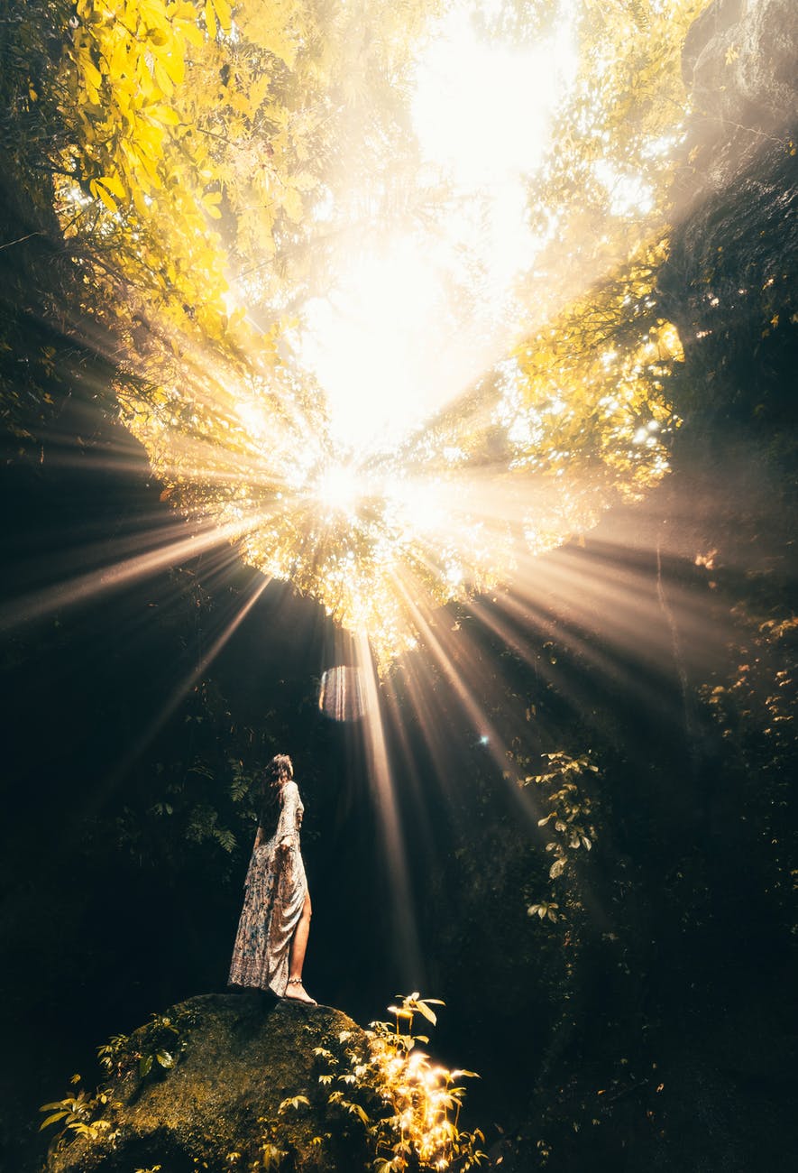 photo of a woman standing in a cave
