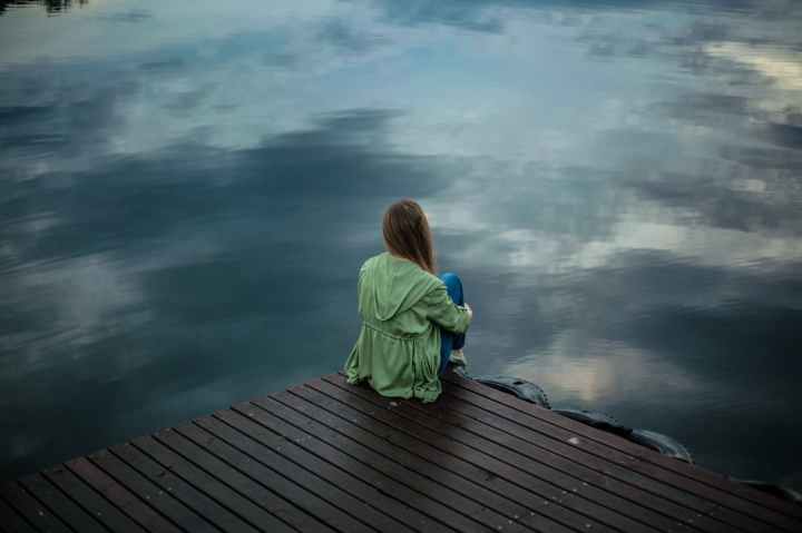 woman sitting on wooden planks